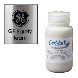 May include: A white bottle of CerMark LMM 6000 laser marking material. The bottle is labeled with the CerMark logo and the text "Laser Marking Materials LMM 6000". The lot number is 152355 and the net weight is 100g.