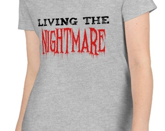 May include: Gray V-neck t-shirt with the text "LIVING THE NIGHTMARE" in black and red lettering.