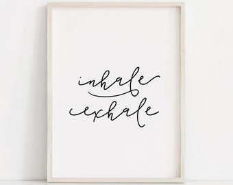 May include: A framed print with the words "inhale" and "exhale" written in black cursive script on a white background.