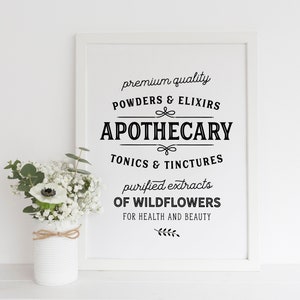 May include: A white framed print with black text that reads "premium quality POWDERS & ELIXIRS APOTHECARY TONICS & TINCTURES purified extracts OF WILDFLOWERS FOR HEALTH AND BEAUTY".