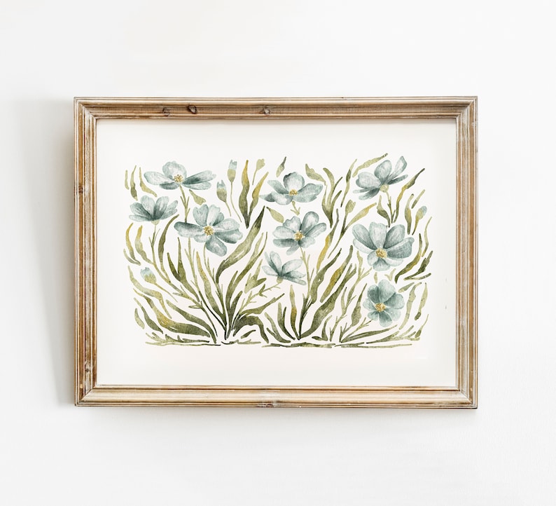 May include: A framed watercolor painting of a floral arrangement featuring blue flowers and green leaves. The flowers are stylized and have a delicate, whimsical feel.