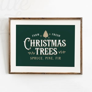 May include: A framed print with a dark green background and the words "CHRISTMAS TREES" in white, with "FARM FRESH" above and "SPRUCE, PINE, FIR" below. The frame is a warm brown color, and the image includes a gold Christmas tree graphic.