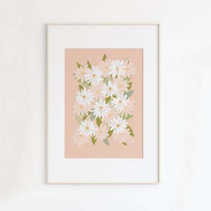 May include: A framed print of a floral illustration featuring white and pink daisies on a peach background.