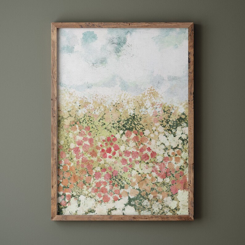 May include: A framed watercolor painting of a field of flowers in shades of pink, white, and green. The sky is a light blue with white clouds.