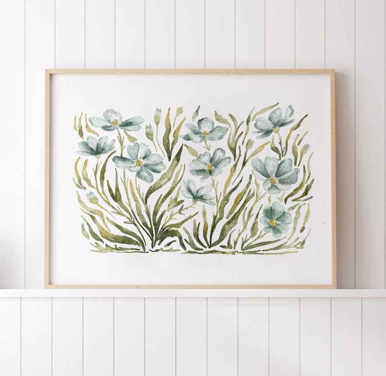 May include: A framed watercolor painting of blue flowers with green leaves on a white background.