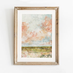 May include: A framed abstract painting of a landscape with a field of flowers in the foreground and a sky with pink, orange, and blue clouds in the background.