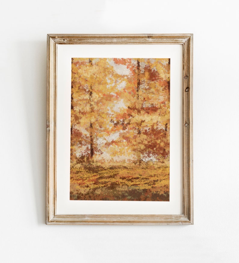 May include: A framed painting of an autumn forest scene with yellow, orange, and brown leaves. The painting is in a light wood frame.