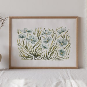 May include: A framed watercolor painting of a cluster of blue flowers with green leaves and stems on a white background.