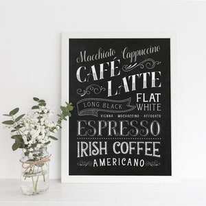 May include: Black and white chalkboard sign with a white frame listing various coffee drinks, including macchiato, cappuccino, cafe latte, long black, flat white, espresso, Irish coffee, and Americano.