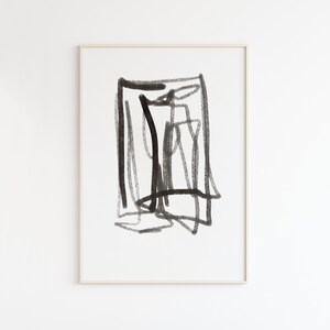 May include: Black and white abstract art print with a geometric design. The print is framed in a simple, light wood frame.
