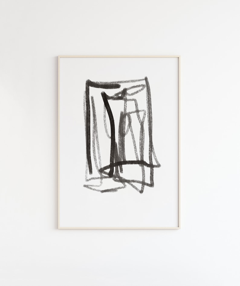 May include: Black and white abstract art print with a geometric design. The print is framed in a simple, light wood frame.