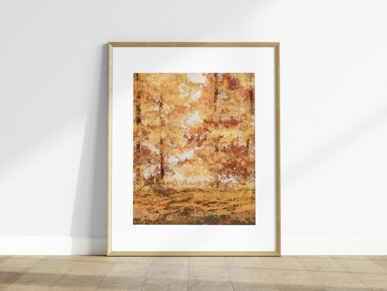 May include: A framed print of a painting depicting a forest scene with trees in shades of orange, yellow, and brown. The trees are in the background, and the foreground is a field of fallen leaves.