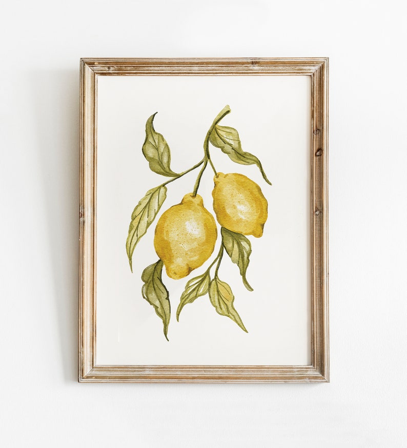 Pode incluir: Pintura em aquarela emoldurada de dois lim&otilde;es amarelos em um galho com folhas verdes. A moldura &eacute; de madeira marrom clara. Os lim&otilde;es t&ecirc;m uma apar&ecirc;ncia texturizada e as folhas s&atilde;o detalhadas com v&aacute;rias tonalidades de verde.