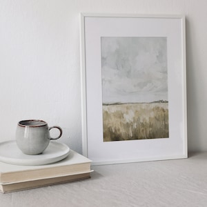 May include: A framed painting of a landscape with a field of tall grass in shades of brown and beige under a cloudy sky.