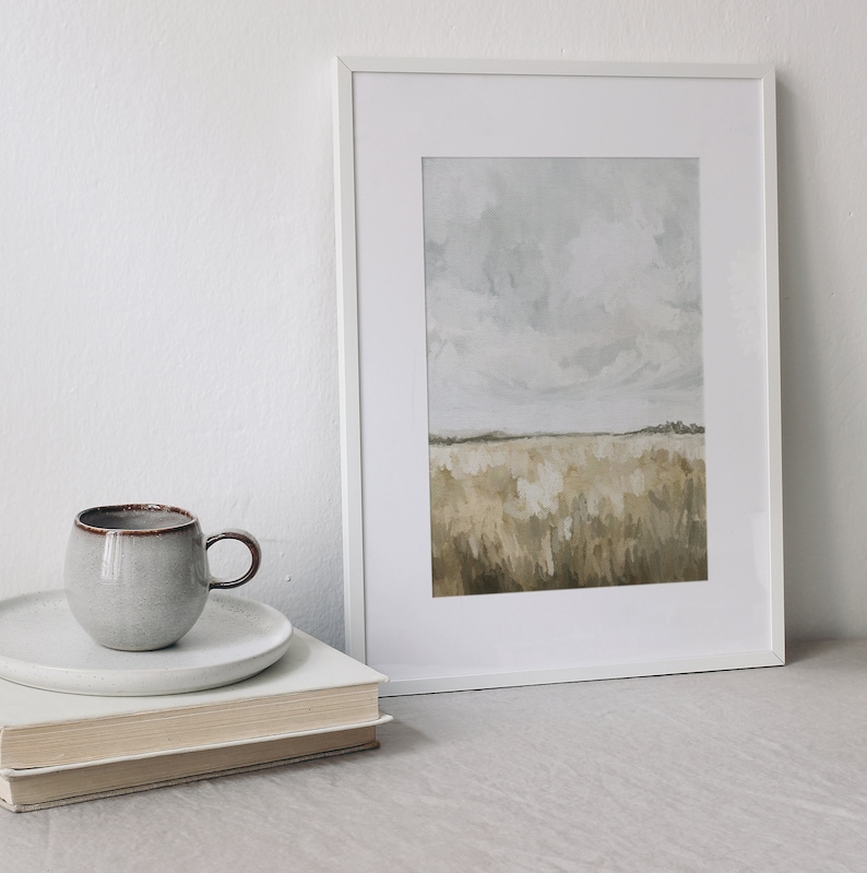 May include: A framed painting of a landscape with a field of tall grass in shades of brown and beige under a cloudy sky.