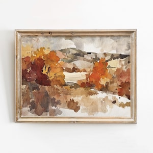 May include: Watercolour landscape painting in a wooden frame. The artwork depicts an autumnal scene with trees in shades of orange, red, and brown. The background shows rolling hills under a cloudy sky. The frame is light brown.