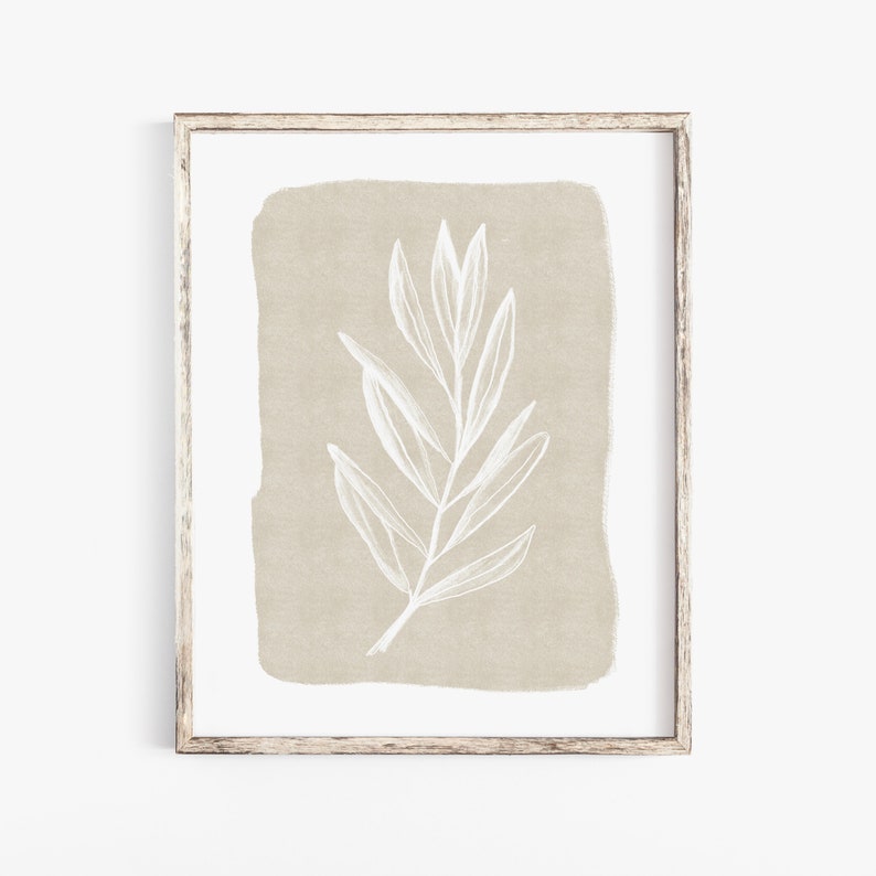 May include: A framed print featuring a white stylised drawing of a branch with leaves on a beige background.