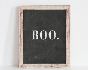 May include: A wooden framed chalkboard with the word "BOO." written in white chalk.