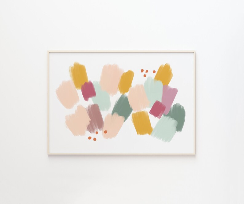 May include: Abstract art print with a colorful design featuring various shades of pink, yellow, green, and brown. The print is framed in a simple white frame.