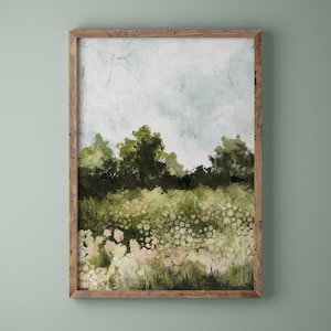 Puede incluir: Una pintura de acuarela enmarcada de un paisaje con un campo de flores blancas en primer plano y una l&iacute;nea de &aacute;rboles en el fondo. El cielo es de un azul claro con algunas nubes.