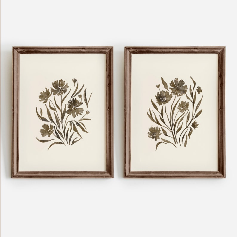 May include: Two framed prints with a watercolor style design of brown flowers and leaves on a white background.