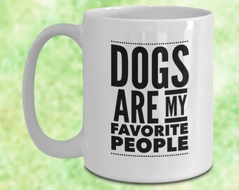 May include: White ceramic coffee mug with a black graphic that reads "Dogs are my favorite people".
