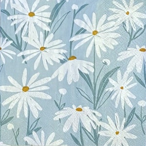 May include: A blue background with a white daisy pattern. The daisies have yellow centres and are arranged in a random pattern.