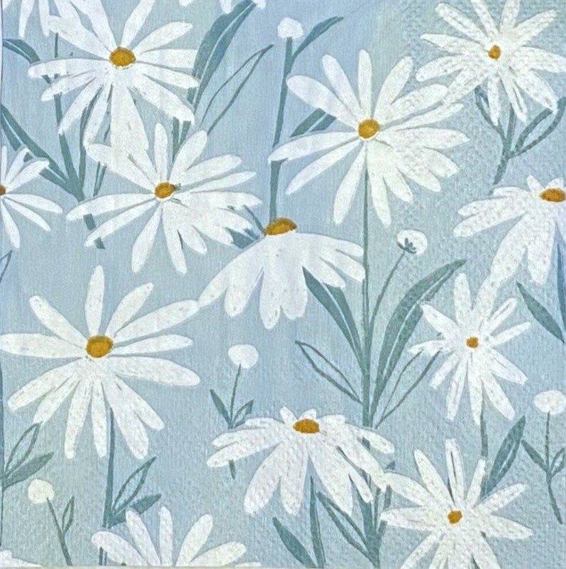 May include: A blue background with a white daisy pattern. The daisies have yellow centres and are arranged in a random pattern.