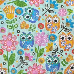 May include: A colorful pattern of owls and flowers on a light blue background. The owls are blue, yellow, and orange with large eyes. The flowers are pink, yellow, and orange with green leaves.