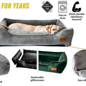 K&ouml;nnte beinhalten: Ein graues Hundebett mit einem schlafenden Hund. Das Bett hat eine rechteckige Form mit erh&ouml;hten Seiten und einem weichen Aussehen. Merkmale sind eine rutschfeste Basis, abnehmbare Kissenbez&uuml;ge und schmutzabweisendes Material.