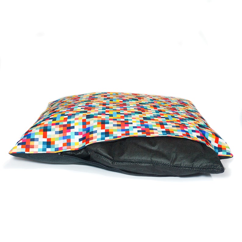 May include: A colorful, pixelated dog bed with a black zippered inner liner. The bed is made of a soft, durable fabric and is perfect for small to medium-sized dogs.