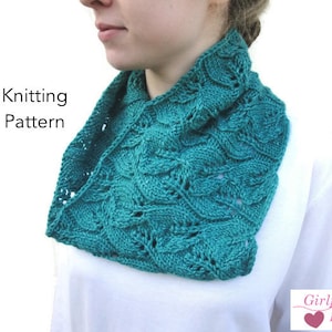 May include: A teal knitted cowl with a leaf pattern is displayed. The cowl is worn around the neck. The words "Knitting Pattern" are on the left side of the image. The Girlpower Designs logo is on the bottom right.