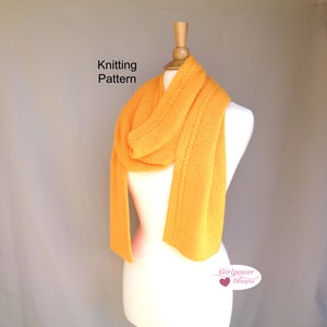 May include: A knitted scarf in a vibrant yellow hue, draped over a mannequin. The scarf features a cable knit design along the edges and is labeled "Knitting Pattern". The Girlpower Designs logo is visible at the bottom right.