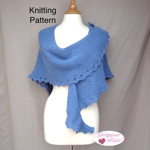 May include: A light blue knitted shawl with a scalloped edge. The shawl is draped over a white mannequin. The text "Knitting Pattern" is at the top of the image. The text "Girlpower Designs" is at the bottom of the image.