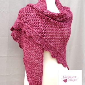 May include: A knitted shawl in shades of pink, displayed on a mannequin. The shawl features a scalloped edge and a textured openwork design. The words "Knitting Pattern" are visible. The Girlpower Designs logo is also visible.