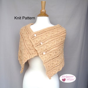 May include: A tan-colored knitted shawl with a cable knit design and three white buttons. The shawl is draped over a mannequin. The text "Knit Pattern" is visible. The Girlpower Designs logo is in the bottom right corner.