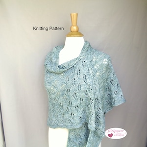 May include: Knitting pattern for a light blue lace shawl. The pattern is called "Girlpower Designs".