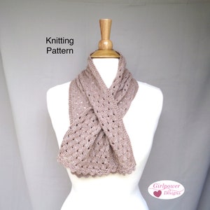 May include: Knitting pattern for a brown, lacy scarf. The scarf is draped around a white mannequin. The text "Knitting Pattern" is at the top of the image. The text "Girlpower Designs" is at the bottom of the image.