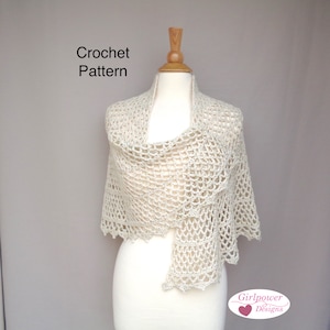 May include: A crocheted shawl in a cream color, draped over a white mannequin. The shawl has a delicate openwork pattern and a scalloped edge. The text "Crochet Pattern" is visible above the mannequin and "Girlpower Designs" is visible below the mannequin.