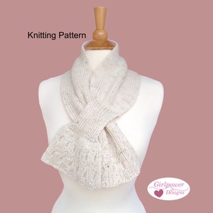 May include: Knitting pattern for a white cowl neck scarf with a textured stitch pattern. The scarf is displayed on a white mannequin. The text "Girlpower Designs" is visible in the lower right corner of the image.
