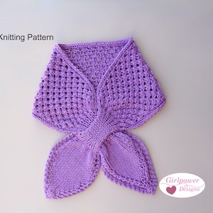 May include: A purple knitted scarf with a butterfly design. The scarf is made with a delicate openwork stitch and has a simple, elegant look. The scarf is tied in a bow at the front.