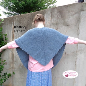 May include: A blue knitted shawl with a scalloped edge. The shawl is draped over the shoulders of a person standing in front of a concrete wall. The text "Knitting Pattern" is visible in the image.