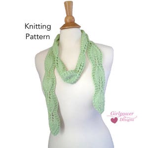 May include: A light green knitted scarf with a leaf pattern. The scarf is displayed on a white mannequin. The text "Knitting Pattern" is at the top of the image and "Girlpower Designs" is at the bottom of the image.
