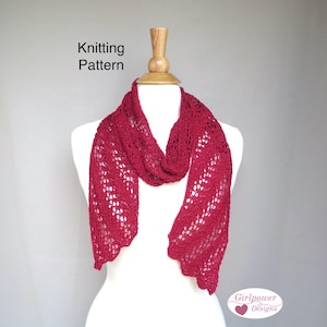 May include: A burgundy knitted scarf with a lacy pattern, displayed on a white mannequin. The scarf is made with a delicate stitch and has a flowing, feminine design. The text "Knitting Pattern" is visible at the top of the image, and the text "Girlpower Designs" is visible at the bottom of the image.