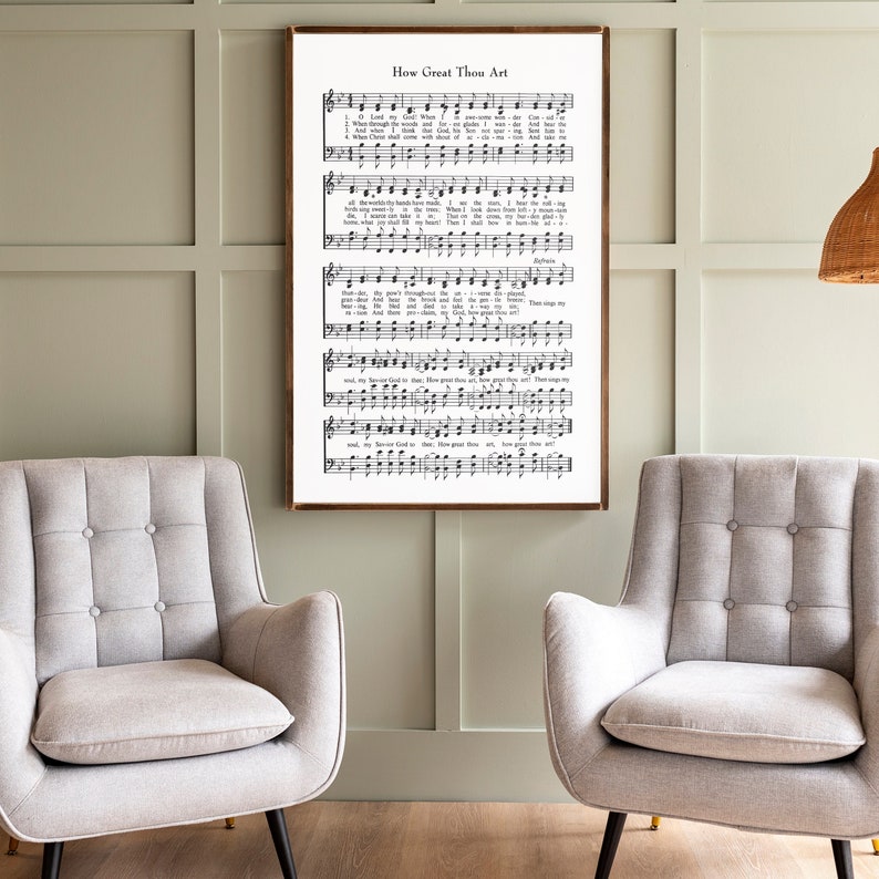 May include: A framed print of a vintage hymn sheet music with the title "How Great Thou Art". The sheet music is printed in black and white on a white background. The print is framed in a simple wooden frame.