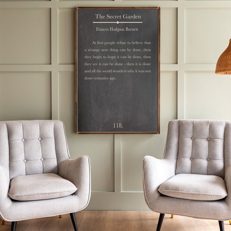 May include: A black chalkboard with a white wooden frame, featuring a quote from "The Secret Garden" by Frances Hodgson Burnett. The quote reads: "At first people refuse to believe that a strange new thing can be done, then they begin to hope it can be done, then they see it can be done - then it is done and all the world wonders why it was not done centuries ago." The number 118 is written at the bottom of the chalkboard.