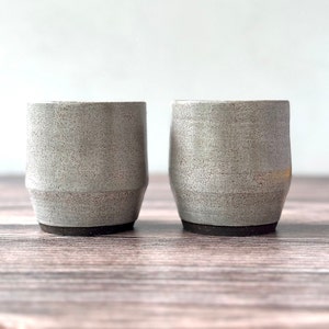 set of two handmade ceramic cups decorated with a speckled gray glaze
