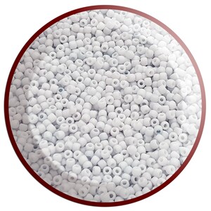 May include: A close-up image of a large quantity of small, white, round seed beads. The beads are arranged in a random pattern and fill the entire frame.