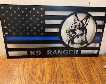 May include: Black metal sign with a silhouette of a German Shepherd dog's head in a circle, a blue and white American flag, and the text "K9 RANGER".