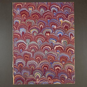May include: A rectangular sheet with a marbled pattern in shades of burgundy, blue, green, and white. The design features a repeating fan-like motif. The bottom right corner has the text "ENGRAVINGS & DTHOS 2025".